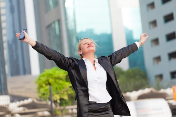 Kyocera Happy,Businesswoman,With,Arms,Outstretched,cityscape