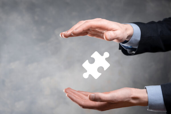 CompTIA Businessman,Hands,Connecting,Puzzle,Pieces,Representing,The,Merging,Of,Two