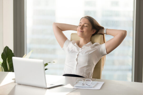 Syncro Calm,Smiling,Businesswoman,Relaxing,At,Comfortable,Office,Chair,Hands,Behind